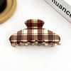 brown gingham claw clip on white background