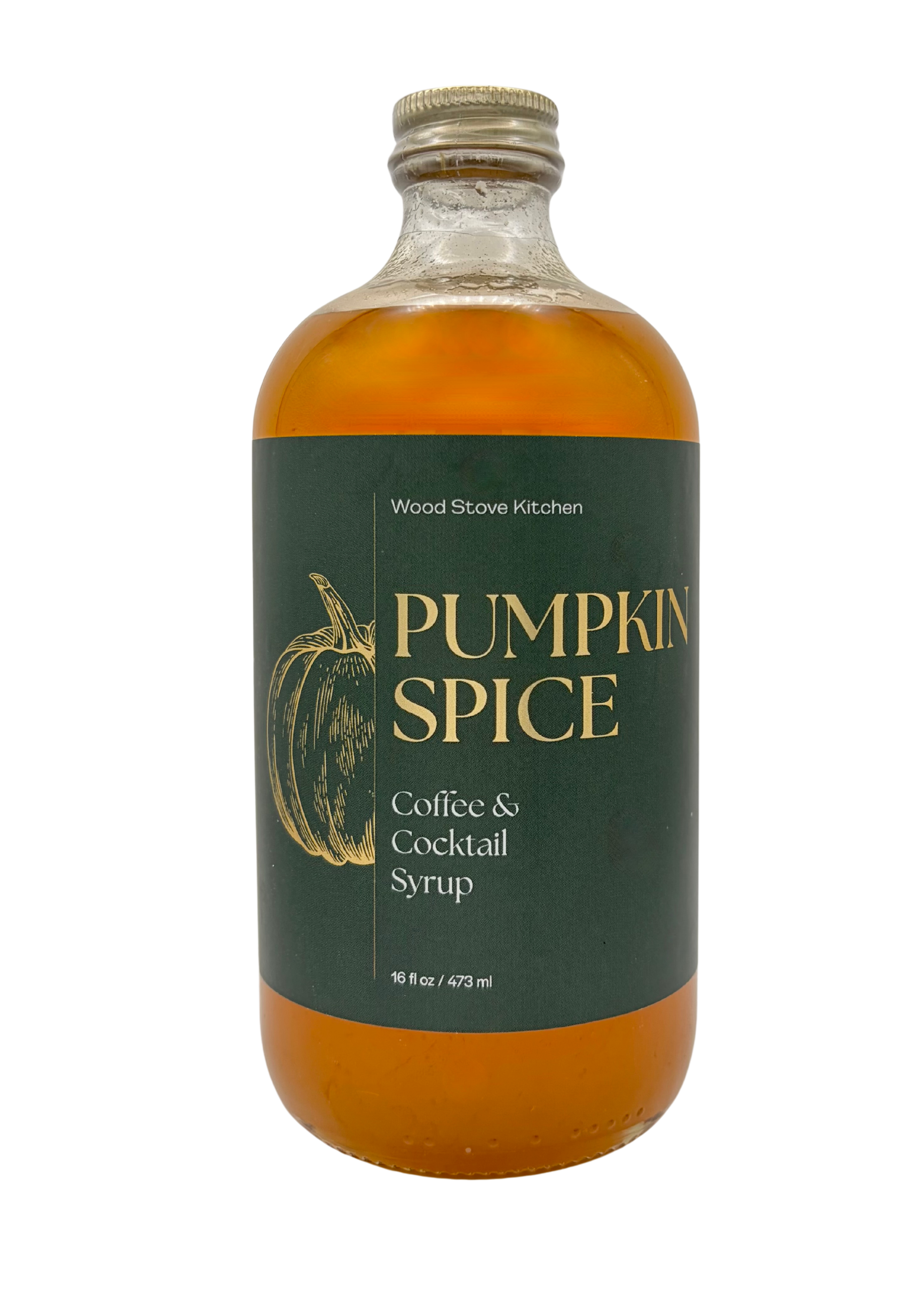 A bottle of Wood Stove Kitchen Pumpkin Spice Coffee & Cocktail Syrup, featuring an amber-colored liquid in a clear glass bottle with a dark green label and gold lettering.