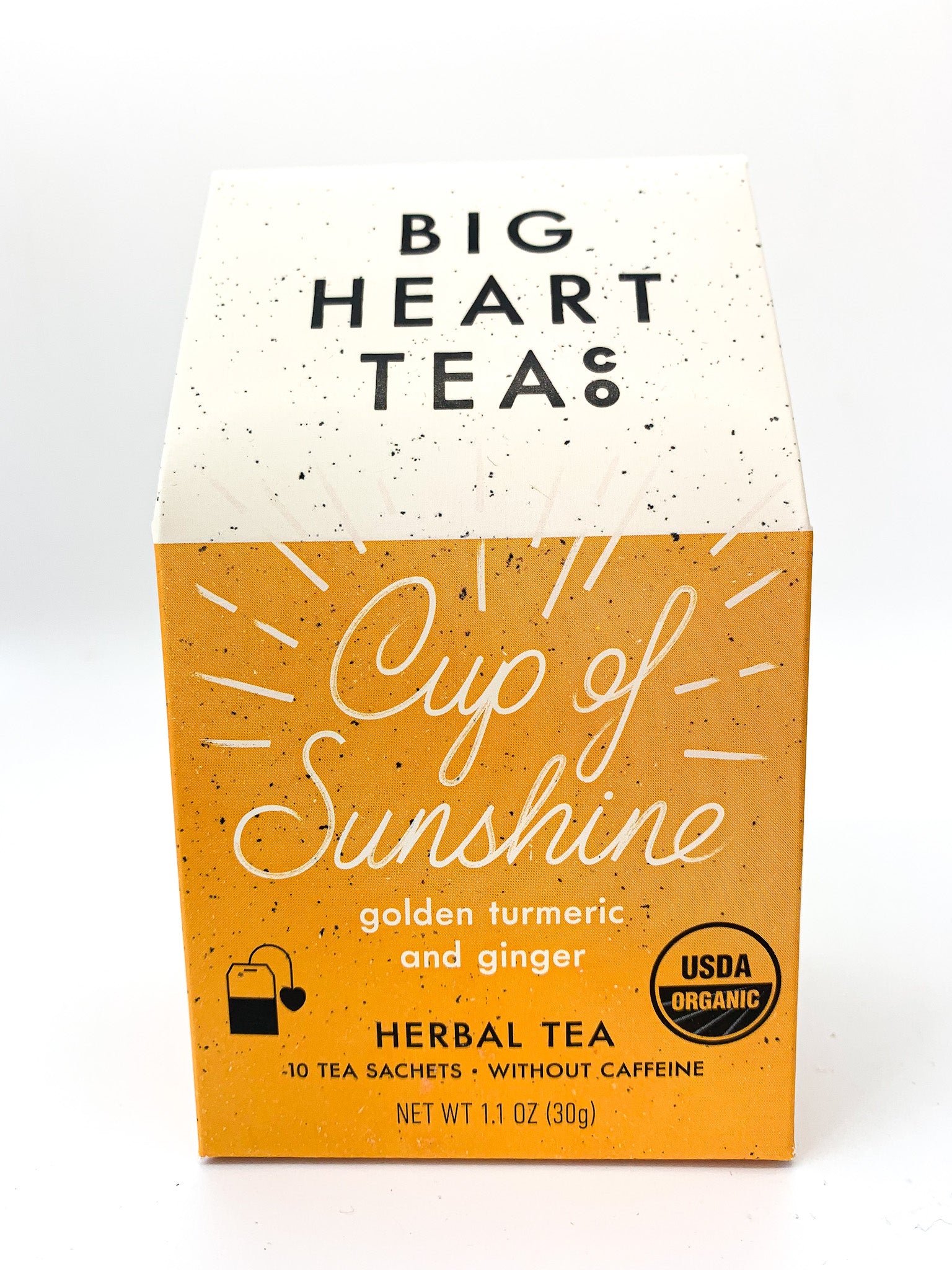 A box of BIG HEART TEAS Cup of Sunshine herbal tea with golden turmeric and ginger. The packaging is brown with white text and speckled patterns.