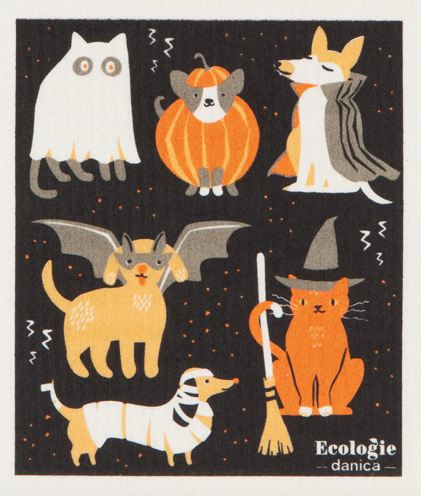A decorative dish towel with various cartoon animals in costume party outfits, primarily in black with a list of eco-friendly product labels at the bottom.