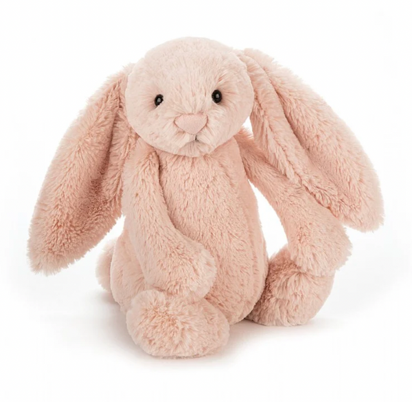 A plush toy depicting a blush pink bunny with long ears, sitting upright.