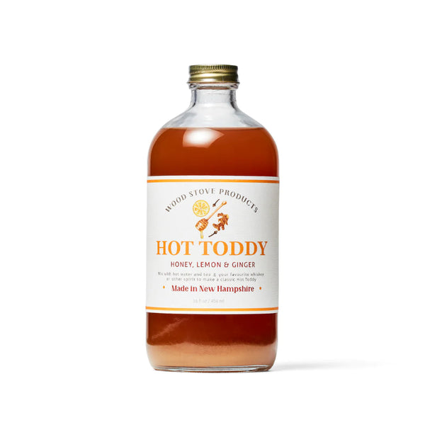 A bottle of Hot Toddy cocktail mix with a label indicating honey, lemon & ginger flavors.